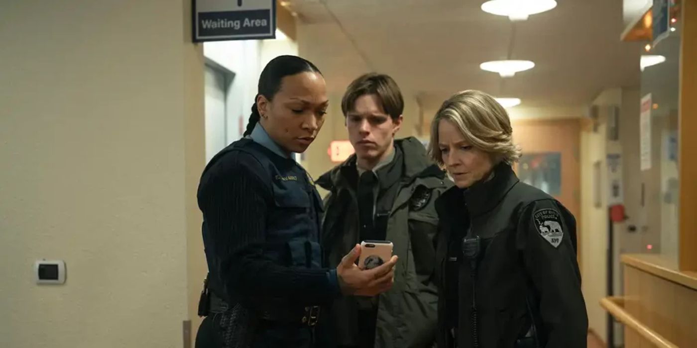 Nevarro, Pete, and Danvers looking at a phone in True Detective Night Country episode 3
