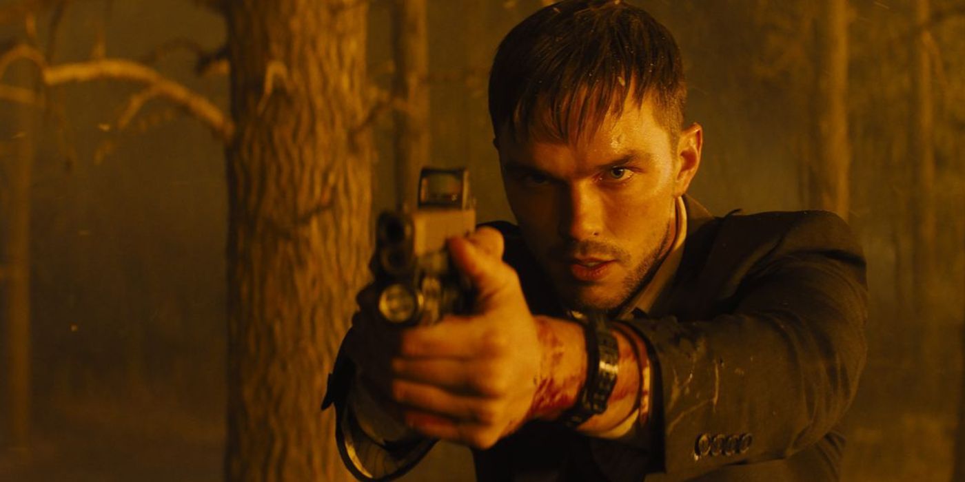 Nicholas Hoult as Patrick levels a gun at Hannah in a burning forest in Those Who Wish Me Dead