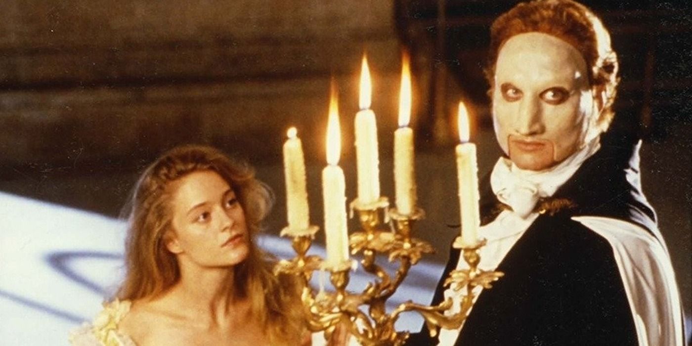 Teri Polo watching Charles Dance hold up a candlebra in Phantom of the Opera (1990)