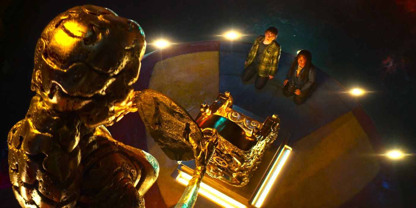 Percy and Annabeth looking up at Hephaestus gold statue and throne in Percy Jackson episode 5