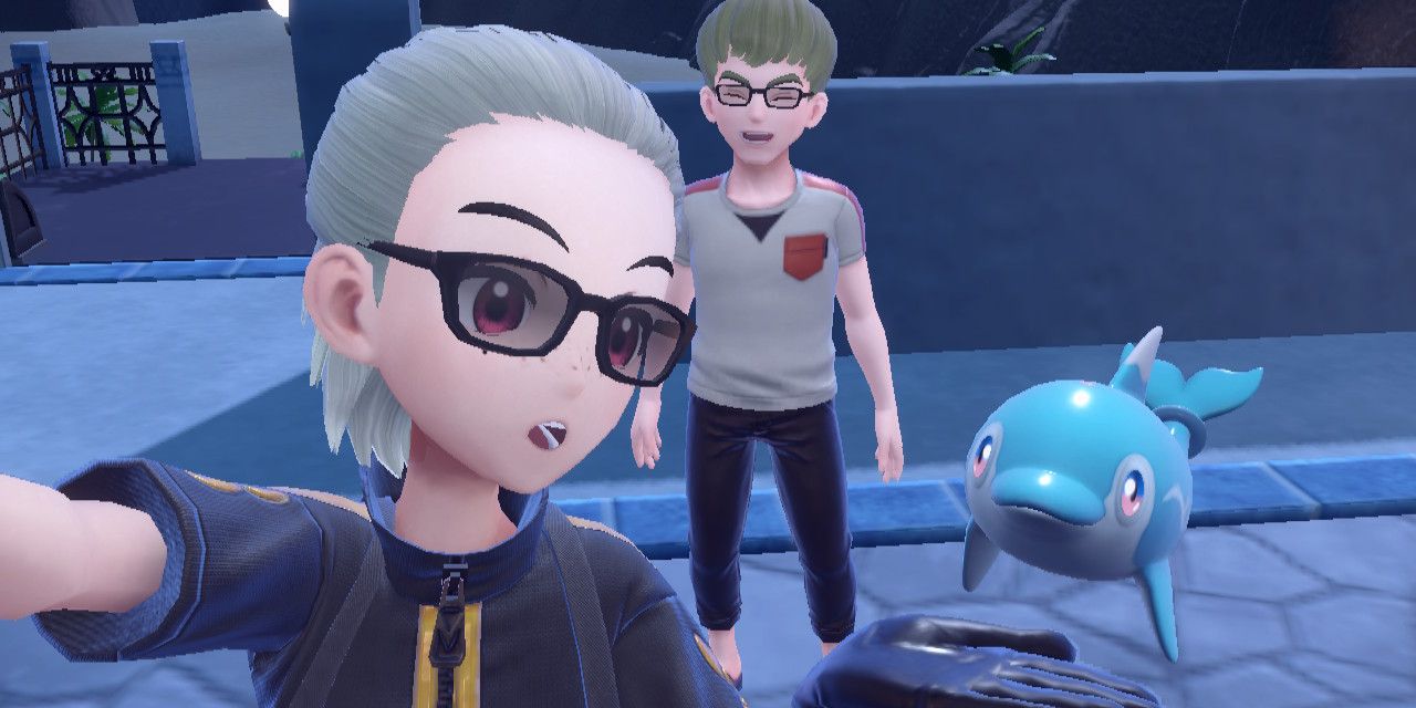 A Pokemon Scarlet and Violet trainer takes a selfie with another trainer and their Finizen.