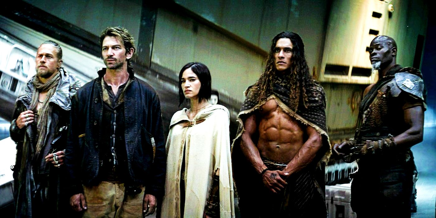 Charlie Hunnam as Kai, Michiel Huisman as Gunnar, Sofia Boutella as Kora, Staz Nair as Tarak, and Djimon Hounsou as Titus standing together and looking serious in Rebel Moon - Part 1: A Child of Fire