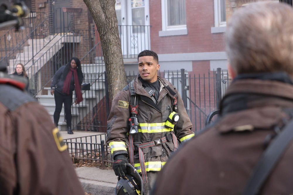 Rome Flynn as Derrick Gibson outside a house in firefighter gear