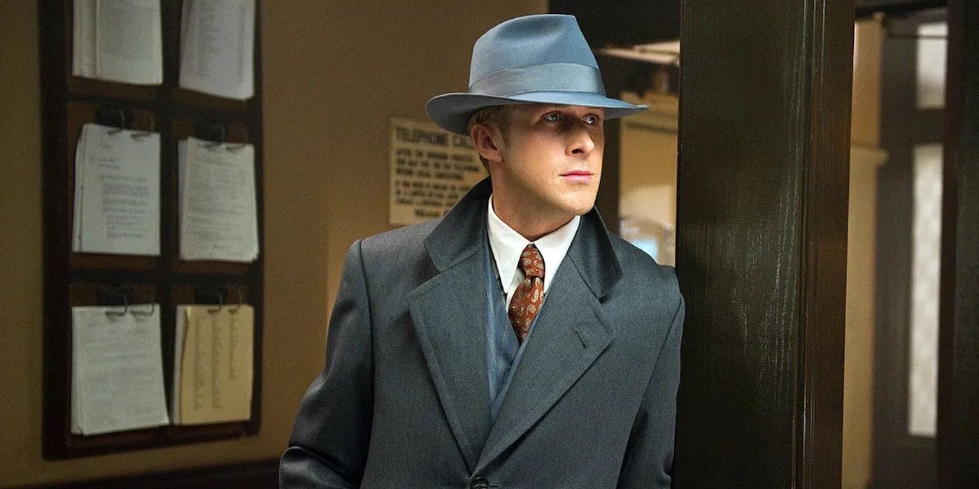 Sgt. Jerry Wooters (Ryan Gosling) leaning against a post wearing a coat and fedora in Gangster Squad.