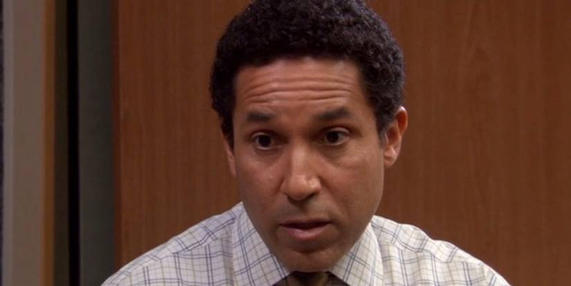 Oscar looking seriously at Michael in The Office