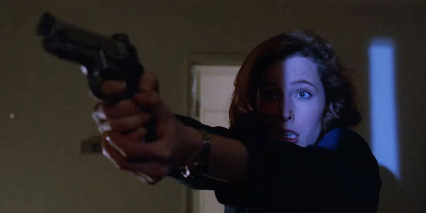 Scully pointing a gun with half of her face in shadow in the X-files