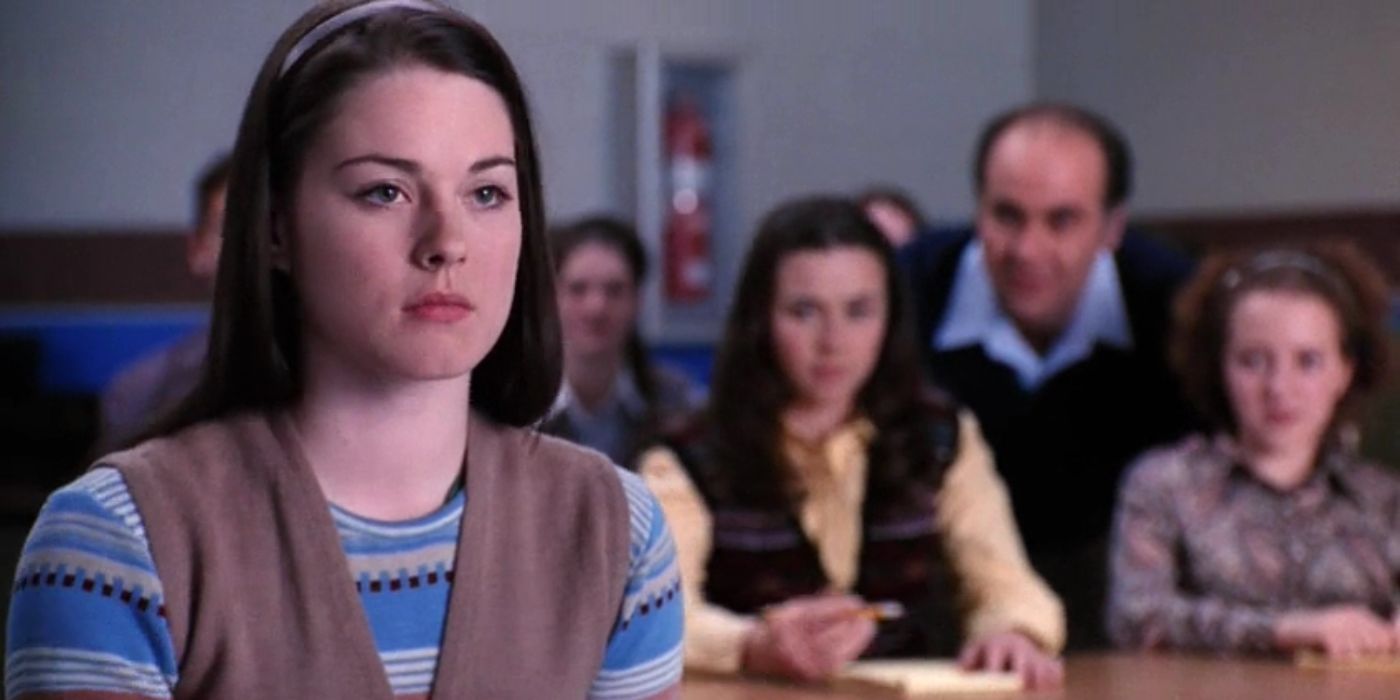 Shelly Weaver (Alexandra Breckenridge) looking annoyed in front of a group of teachers and students in Freaks and Geeks.