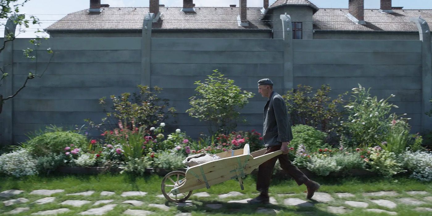 Soldier carrying a wheelbarrow in The Zone of Interest
