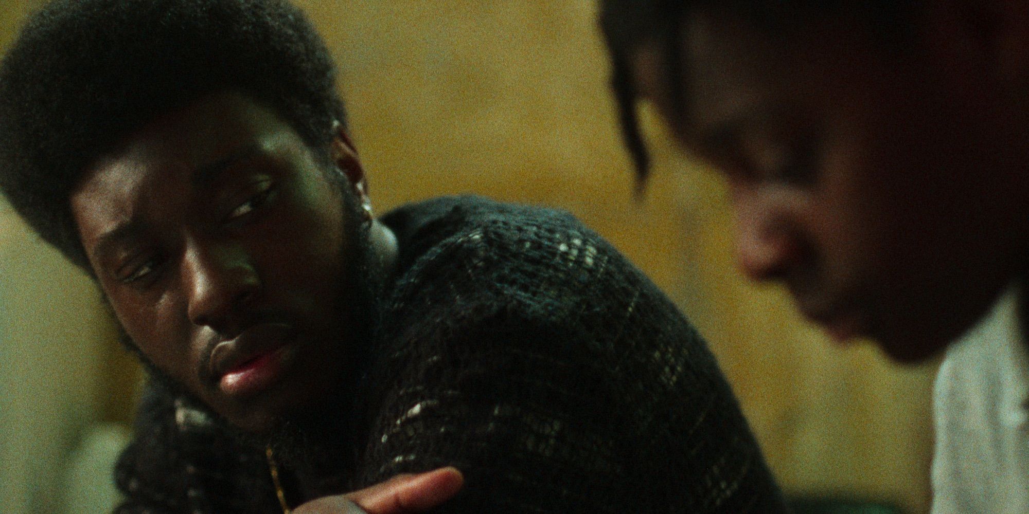 Staples looks at Benji from the side in The Kitchen