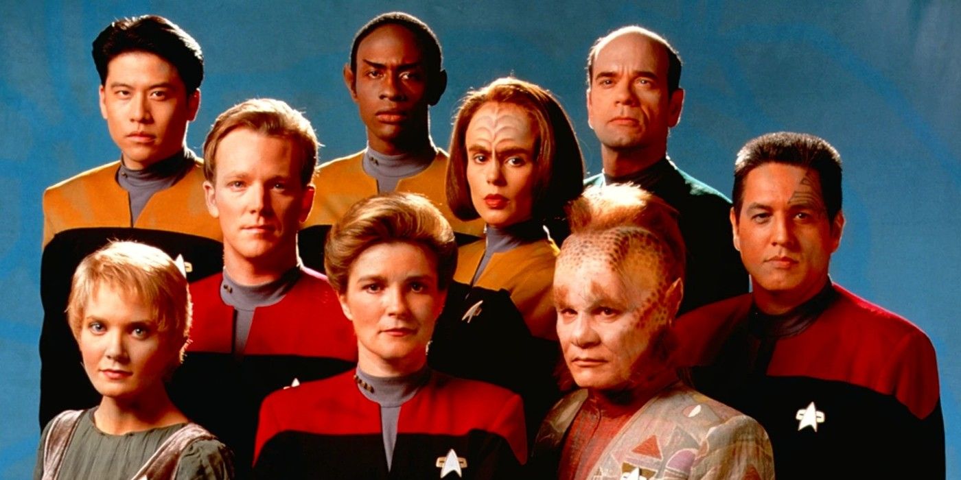 The cast of Star Trek: Voyager season 2 stands together and stares at the camera.