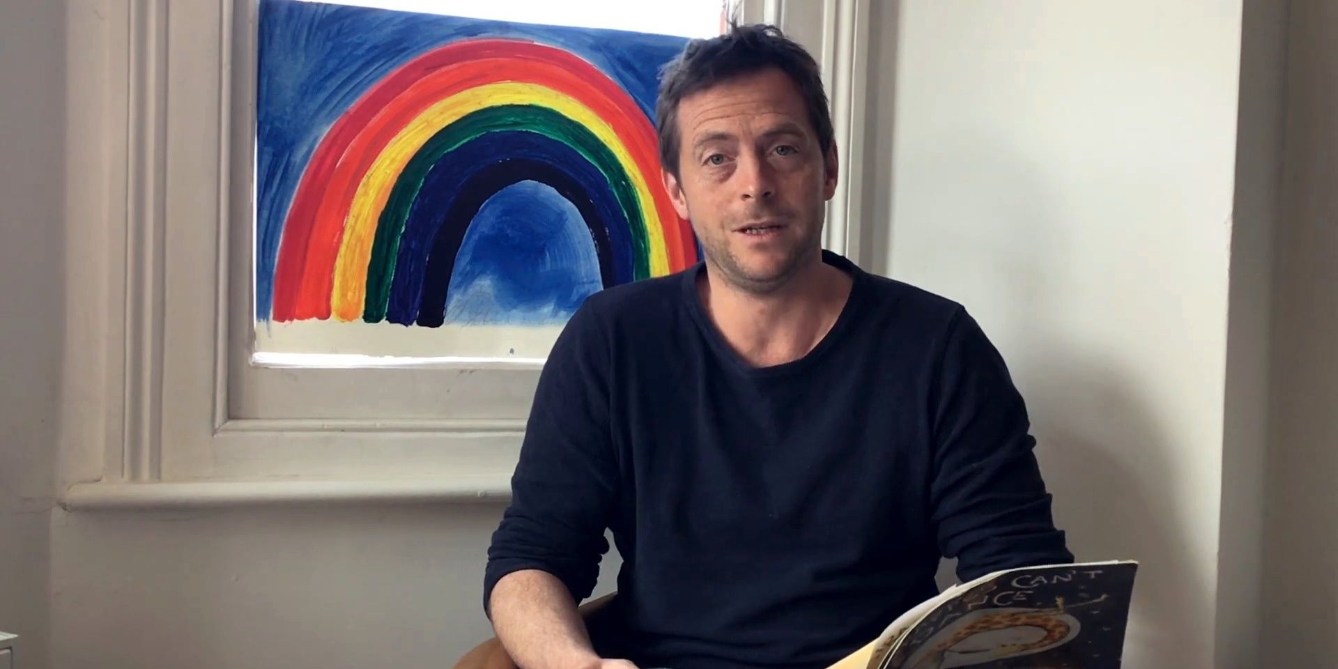 Stephen Campbell Moore reading a children&rsquo;s book.