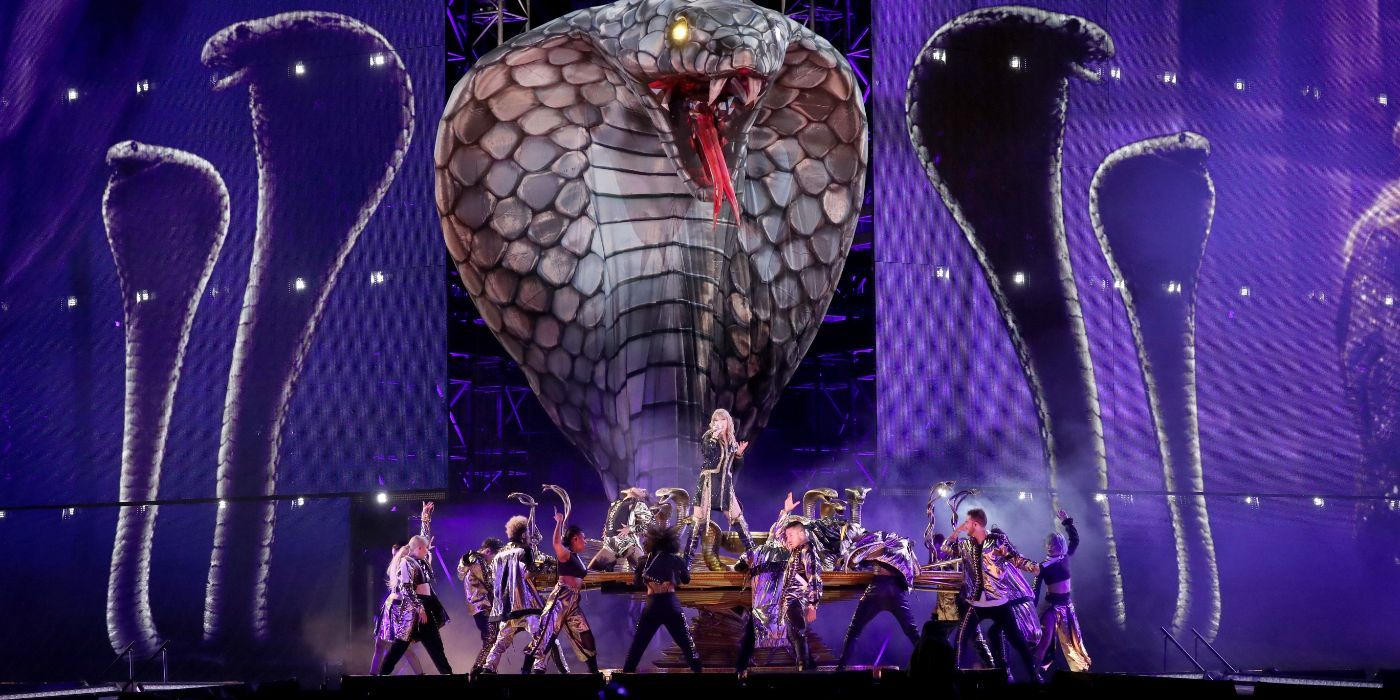 Taylot Swift singing in front of a giant cobra with background dancers in Taylor Swift Reputation Stadium Tour.