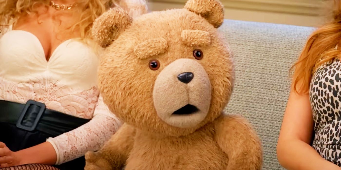 Ted sitting on the couch between two women and looking surprised in the Ted prequel show