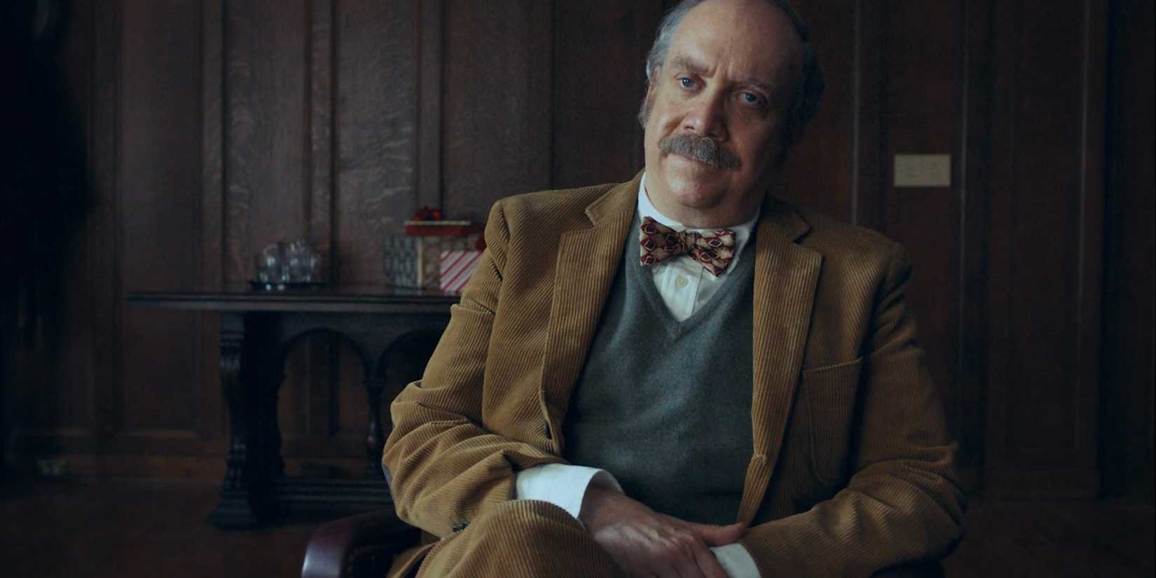 Paul Giamatti as Paul Hunham sitting in the office in The Holdovers.