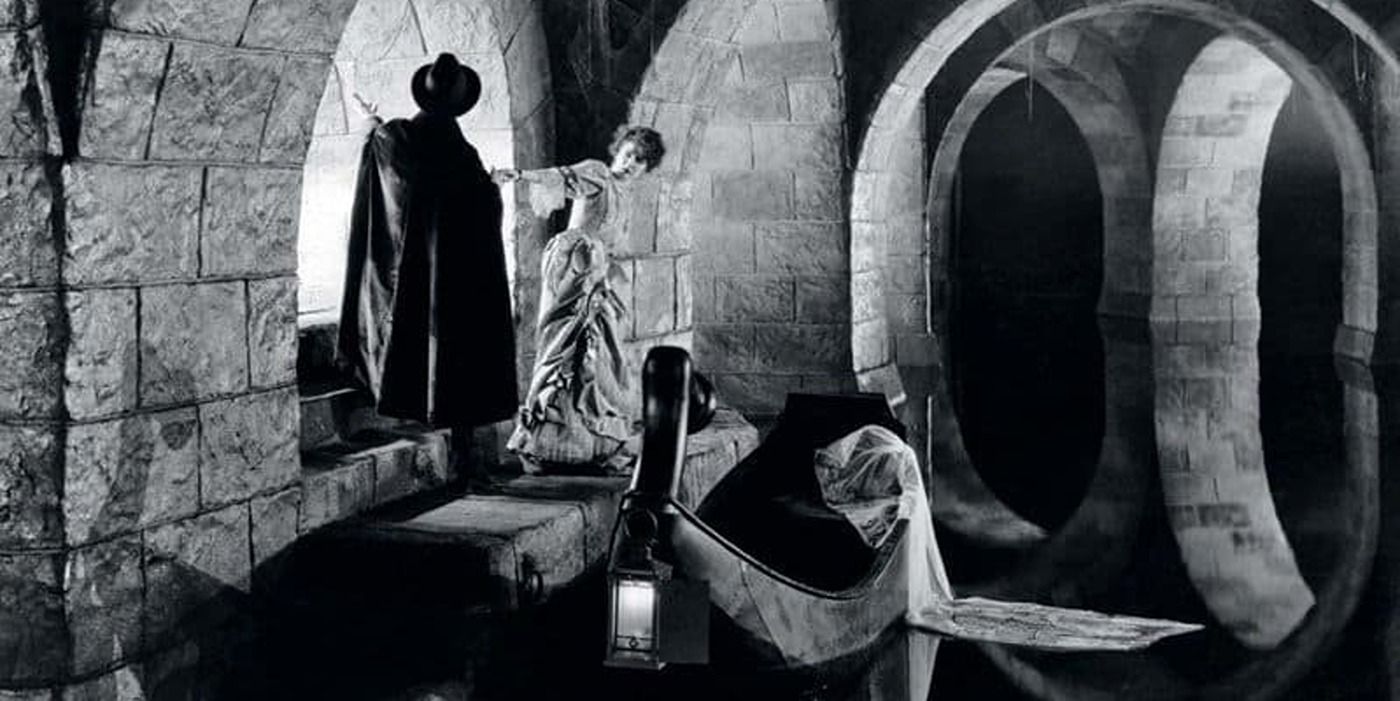 The Phantom leading Christine to his boat for the ride to the lair in the 1925 film
