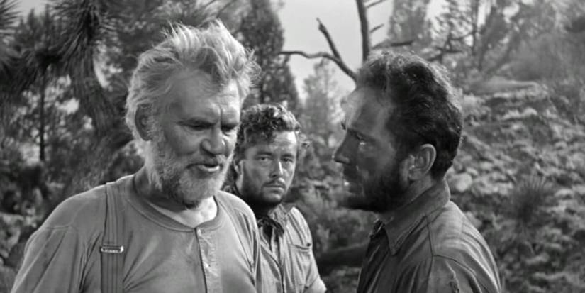 Humphrey Bogart as Fred C. Dobbs talking to Walter Huston as Howard in The Treasure of the Sierra Madre.