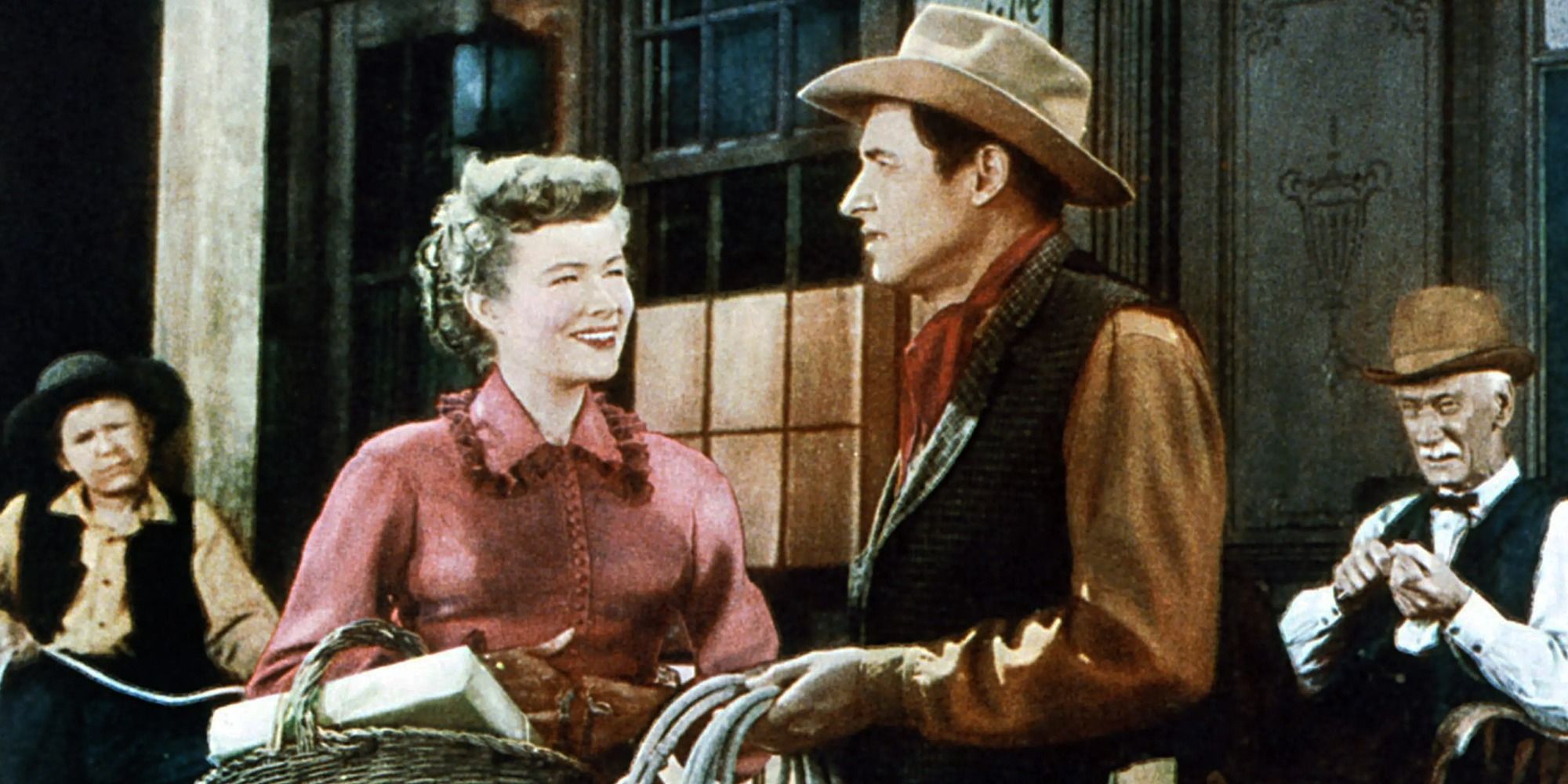 Will Rogers Jr., Nancy Olson, and other Boy from Oklahoma cast members standing on a porch