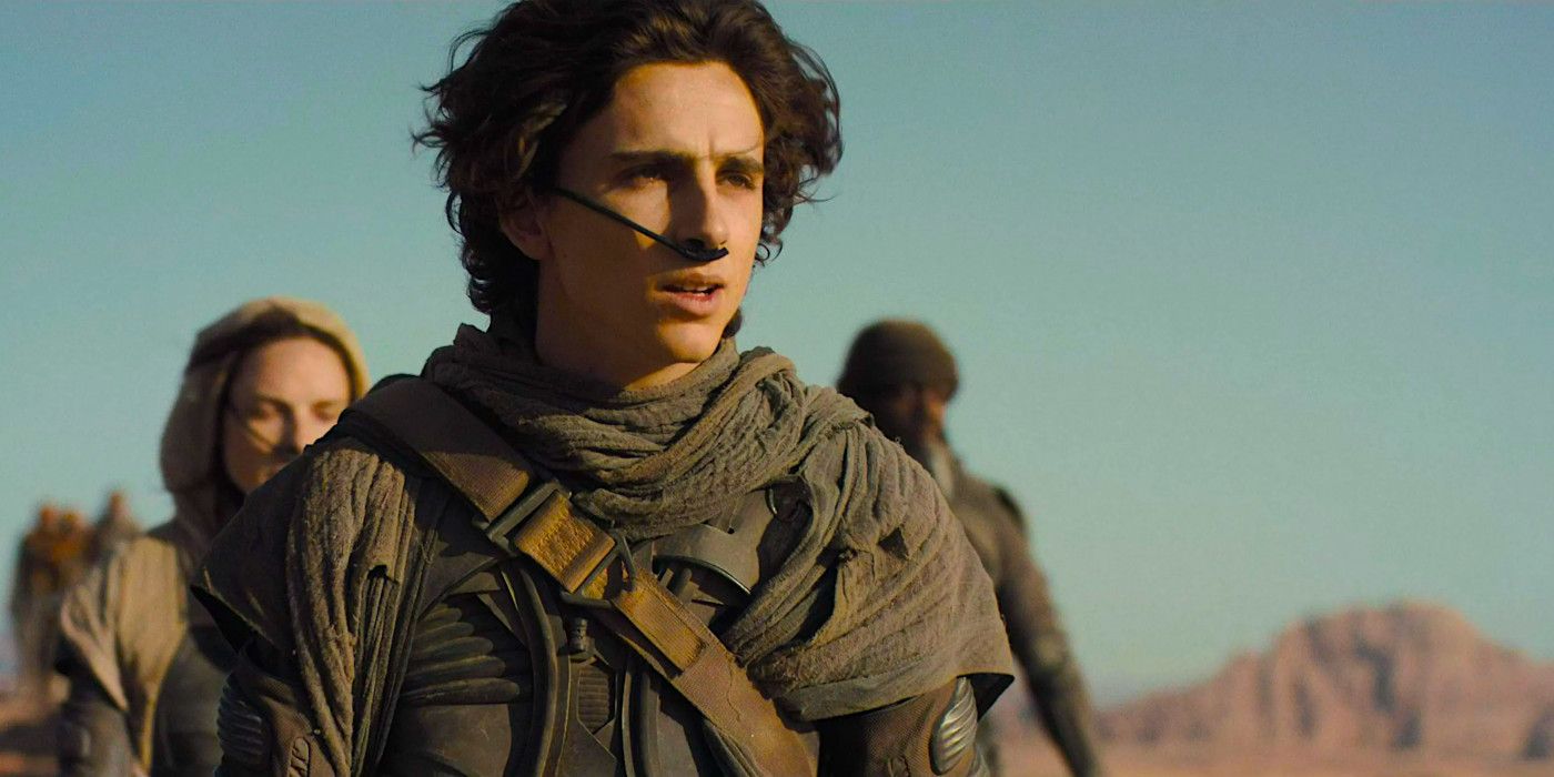 Timothee Chalamet in ragtag attire wearing a respiration device in his nose while crossing the desert in Dune: Part One.