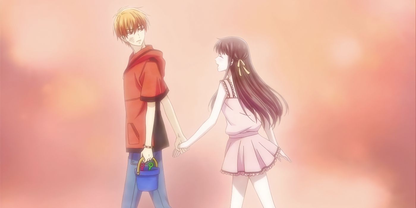 Kyo looks back at a smiling Tohru as he carries a bucket in one hand and holds her hand with the other from Fruits Basket.