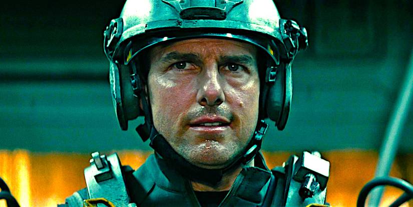 Tom Cruise perspiring while wearing heavy military gear in a scene from Edge of Tomorrow