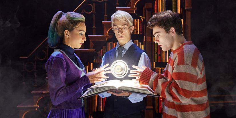 Albus, Scorpius, and Delphini looking at the time turner in Harry Potter and the Cursed Child.