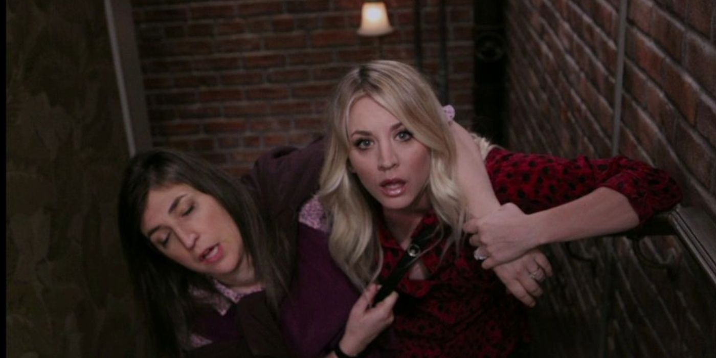 Penny carrying a drunken Amy up the stairs in The Big Bang Theory