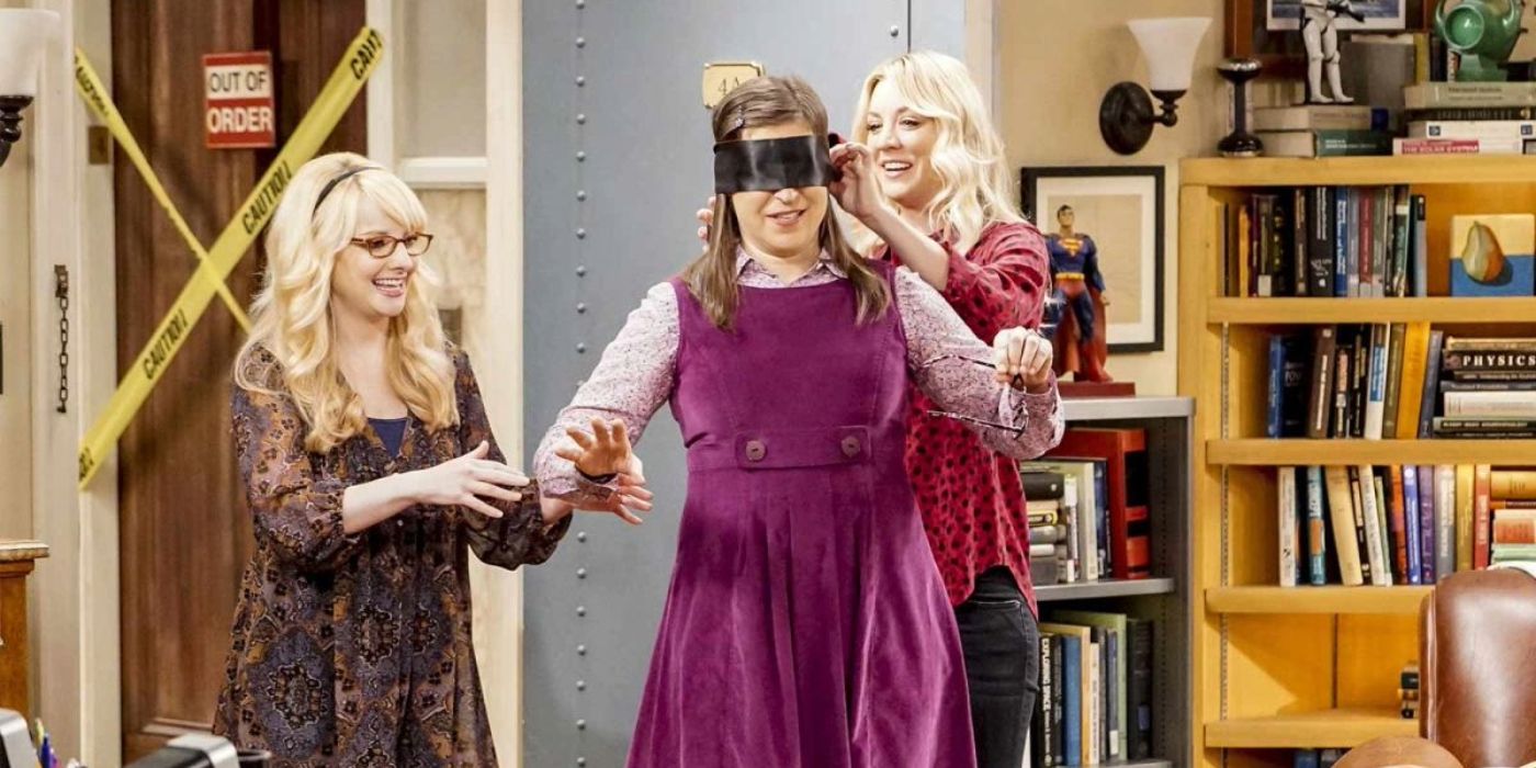 Penny and Bernadette with a blindfolded Amy in The Big Bang Theory