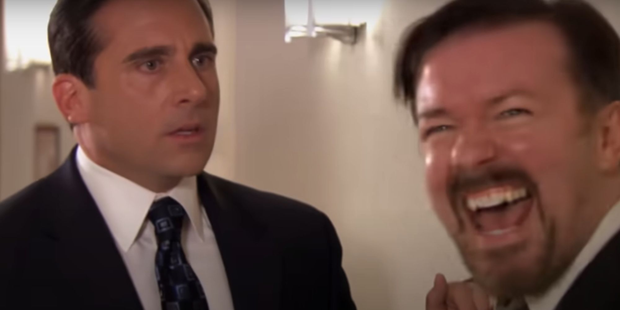 Steve Carrell as Michael Scott staring at Ricky Gervais as David Brent in The Office