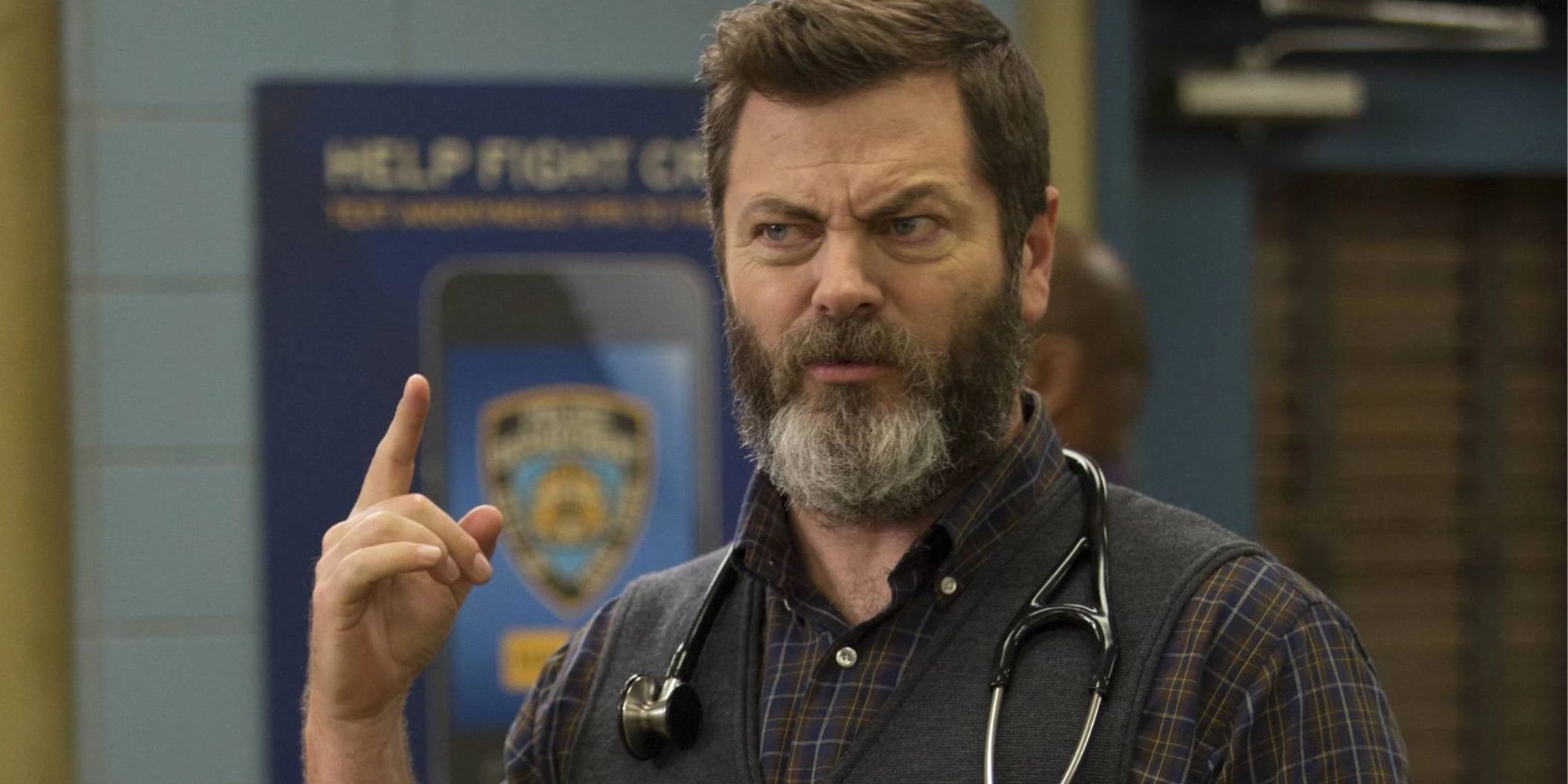 Nick Offerman as Frederick in Brooklyn Nine-Nine pointing upwards with a stethoscope around his neck