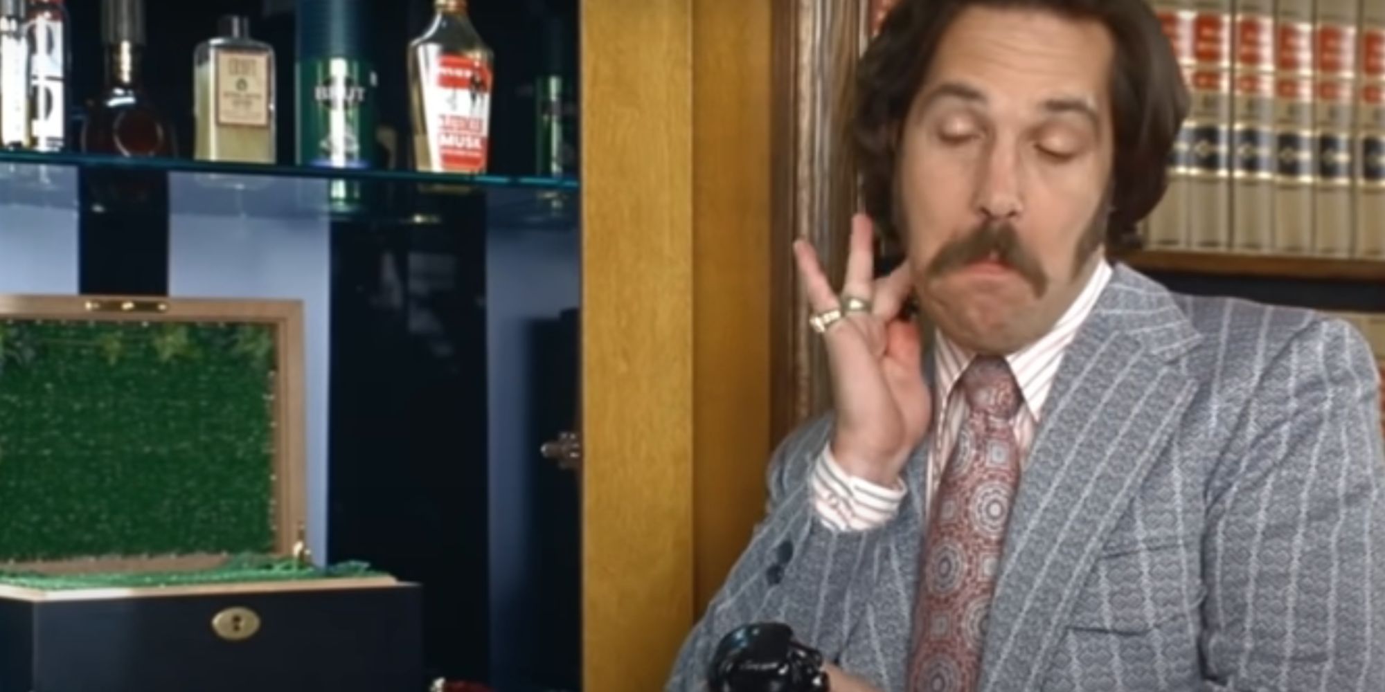 Paul Rudd as Brian Fantana applying his Sex Panther cologne in Anchorman