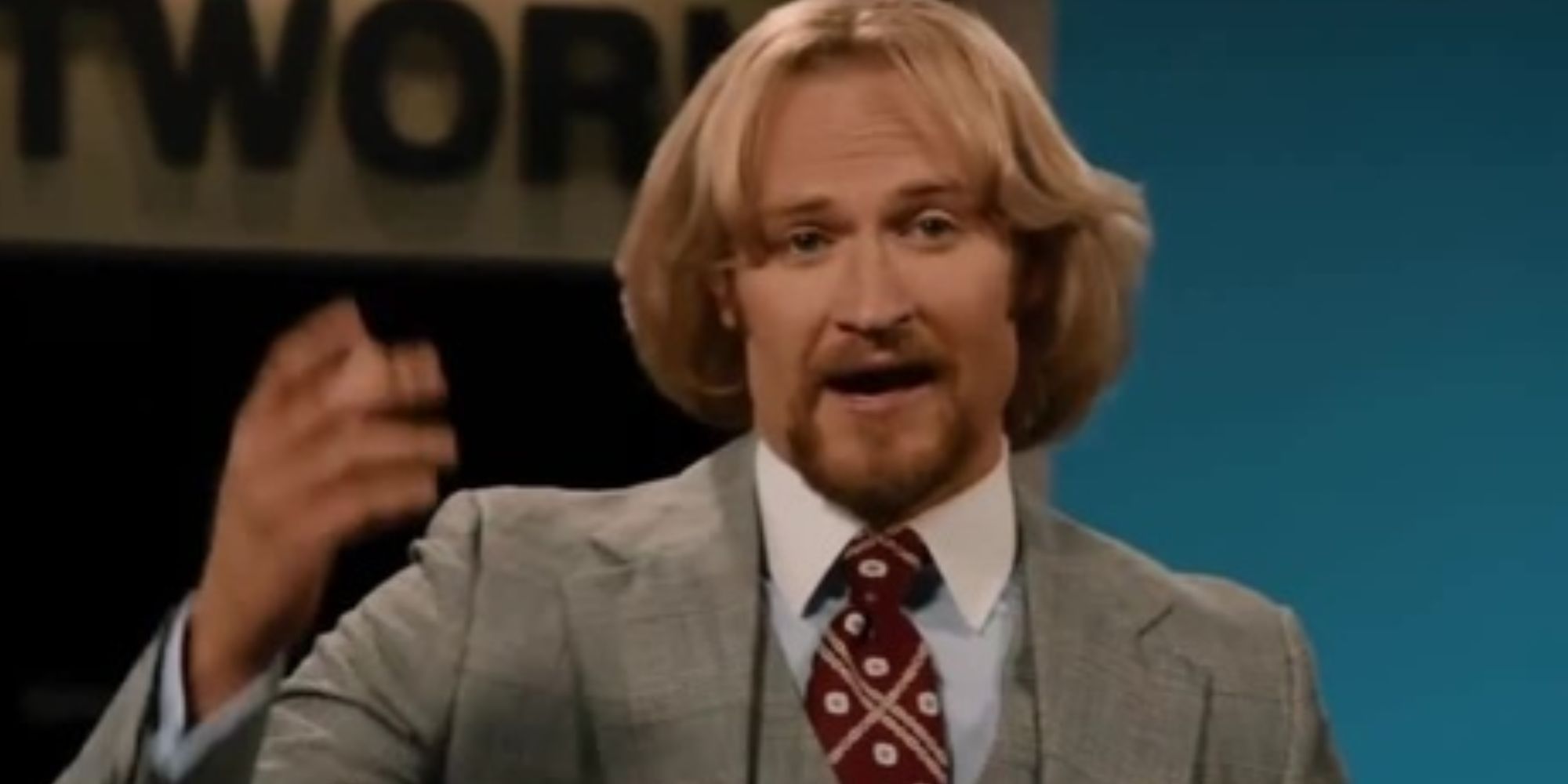 Josh Lawson gesticulating as Kench Allenby in Anchorman 2: The Legend Continues