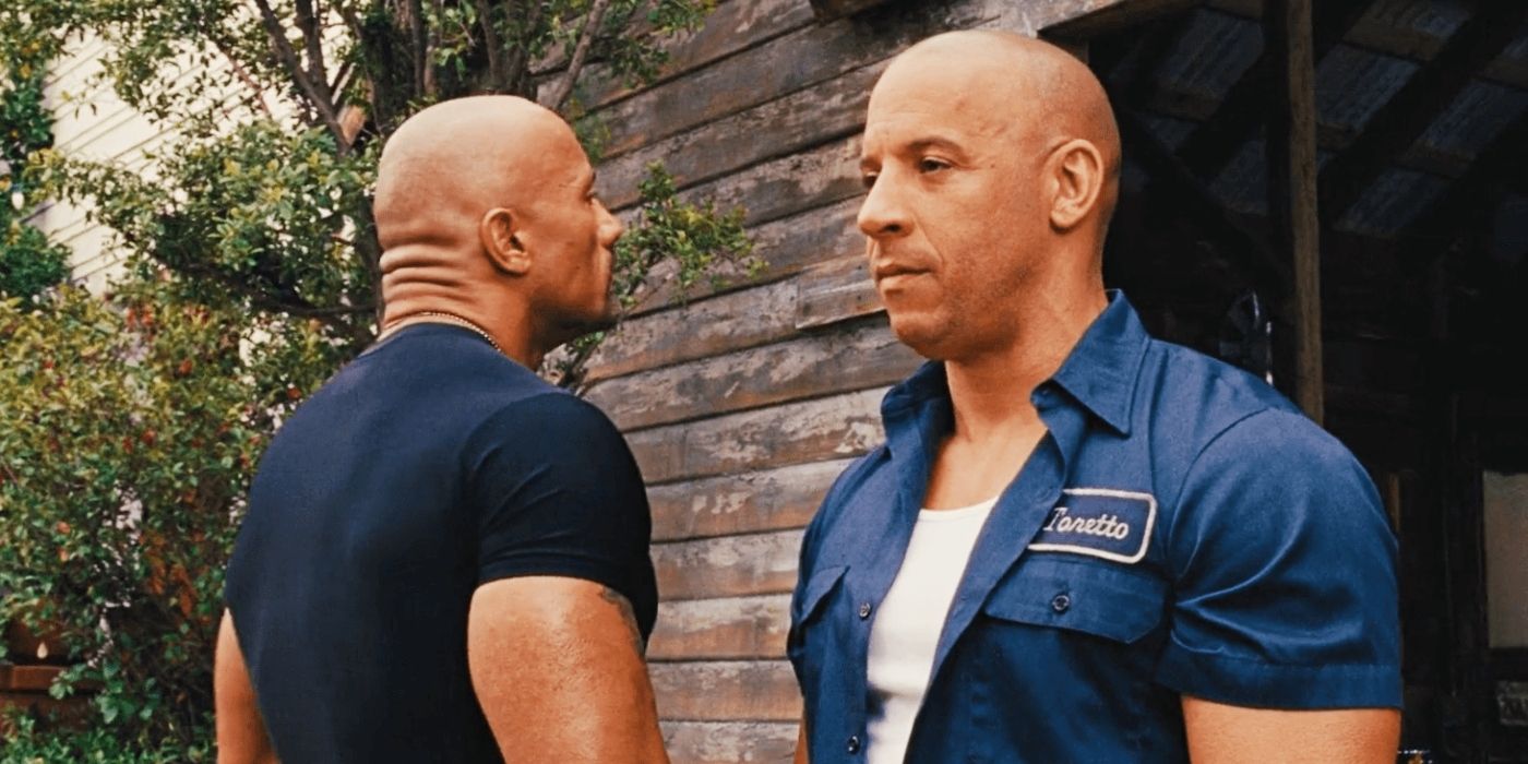 Vin Diesel as Dom and Dwayne Johnson as Hobbs looking over each other's shoulders in Fast and Furious 6