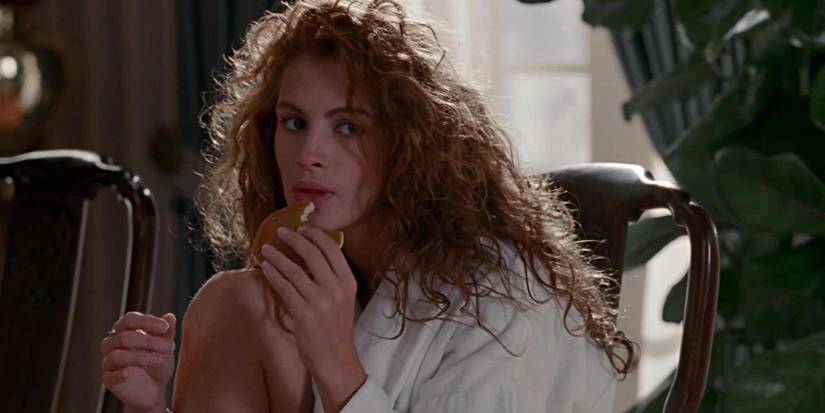 Vivian eating a pancake while curled up in a chair in Pretty Woman