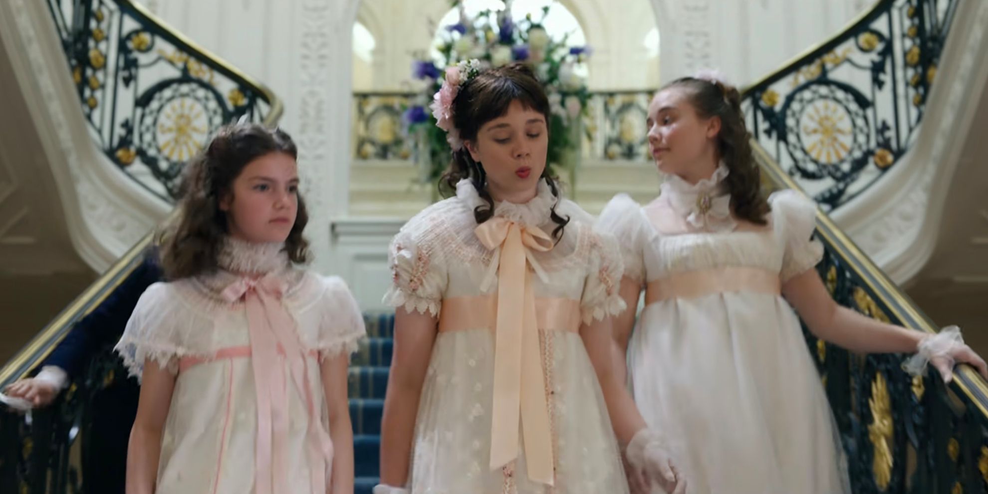 Francesca, Hyacinth and Eloise walking down the stairs in Bridgerton