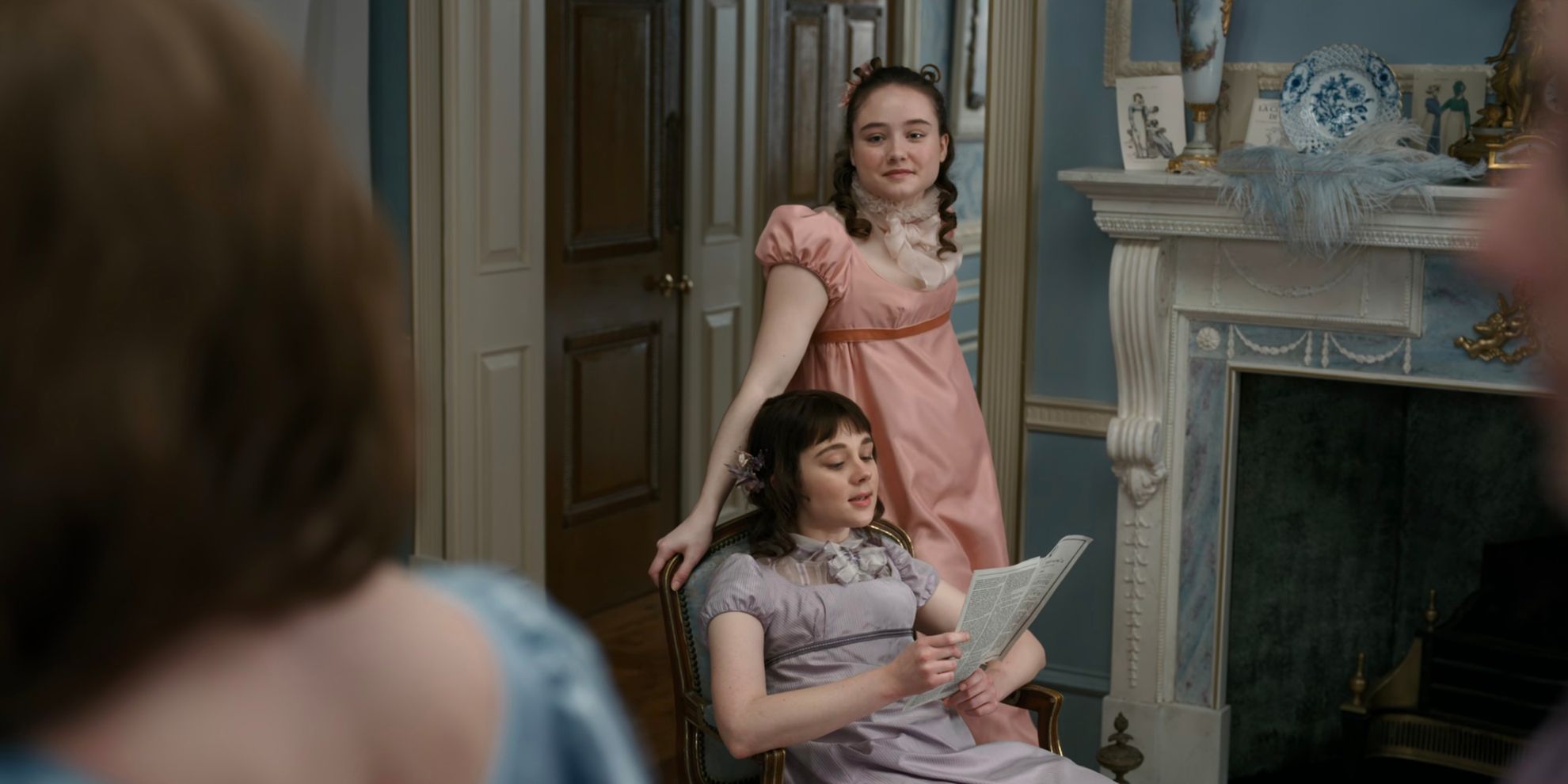 Francesca Standing Beside Eloise Reading a Newspaper in Bridgerton Season 1 Episode 1