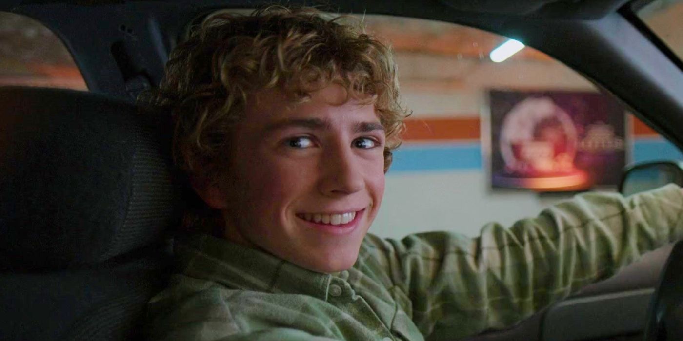 Walker Scobell smiling behind the wheel of a car in Percy Jackson and the Olympians season 1