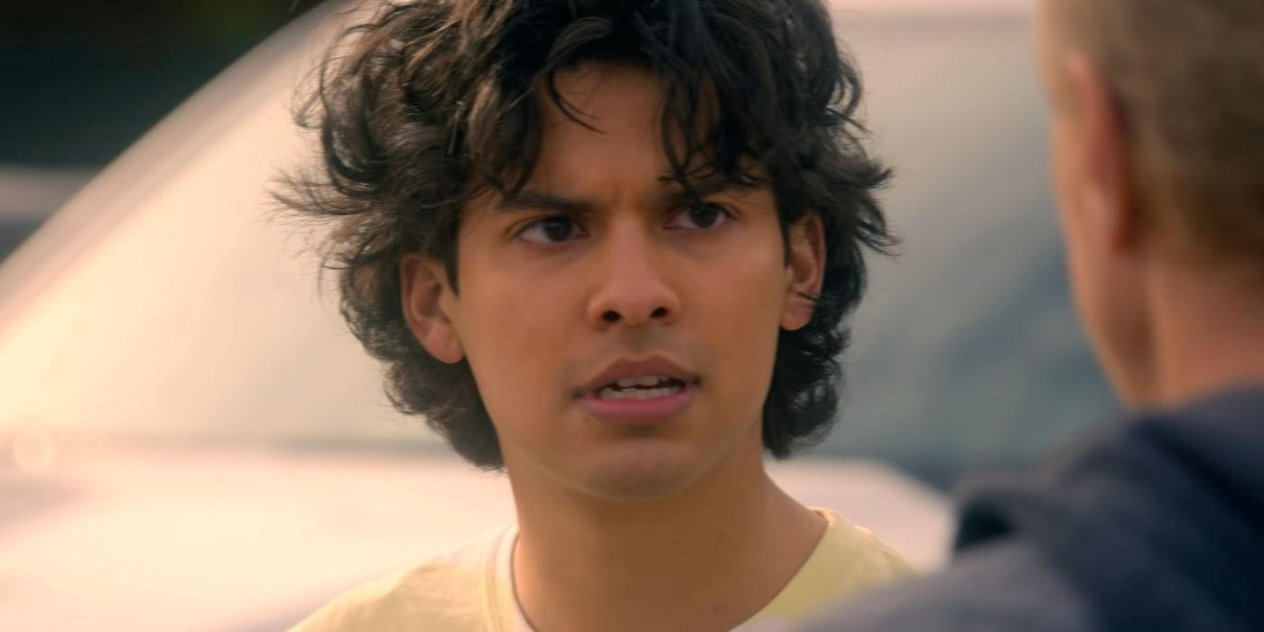 Xolo Maridueña as Miguel Diaz speaks to someone in Cobra Kai.