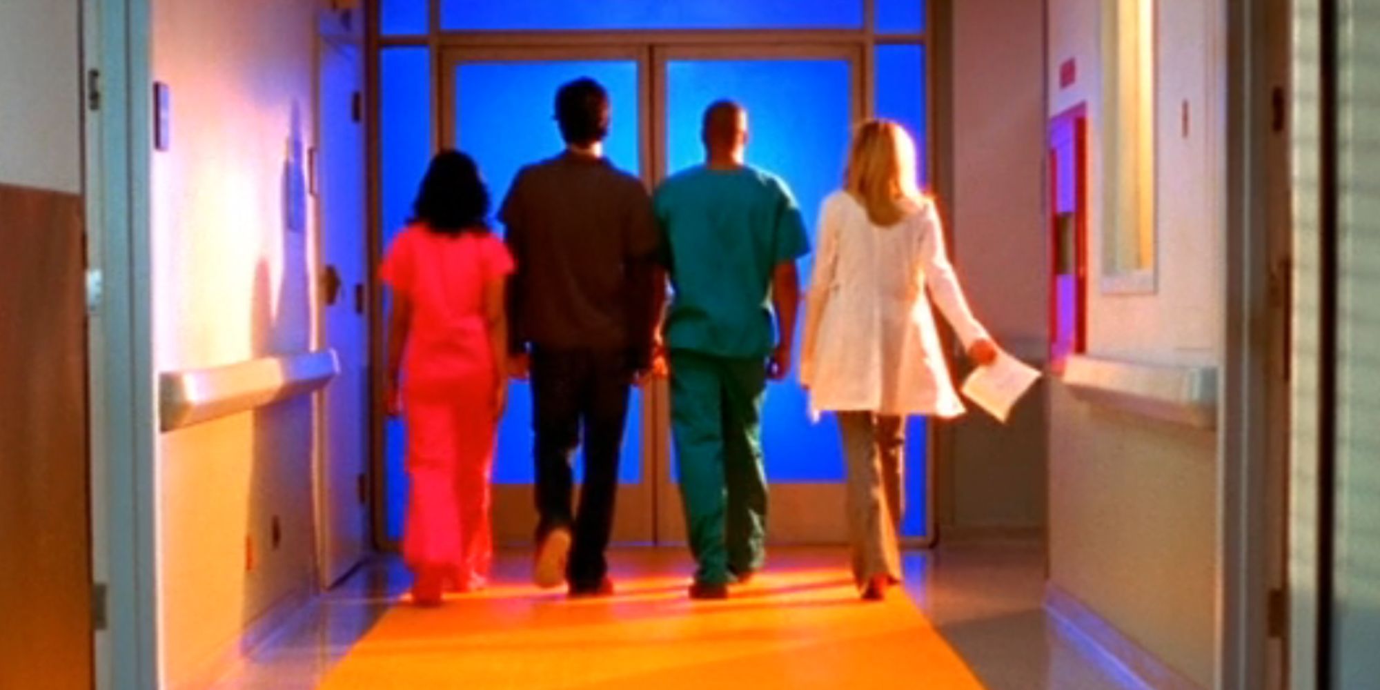 Carla, JD, Turk, and Elliot walking on a yellow path toward the exit in Scrubs