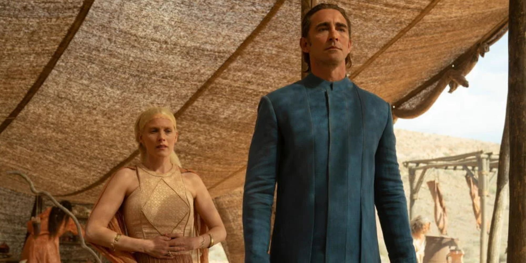 Lee Pace in a blue tunic as Cleon XIII in Foundation as Laura Birn's Demerzel trails behind