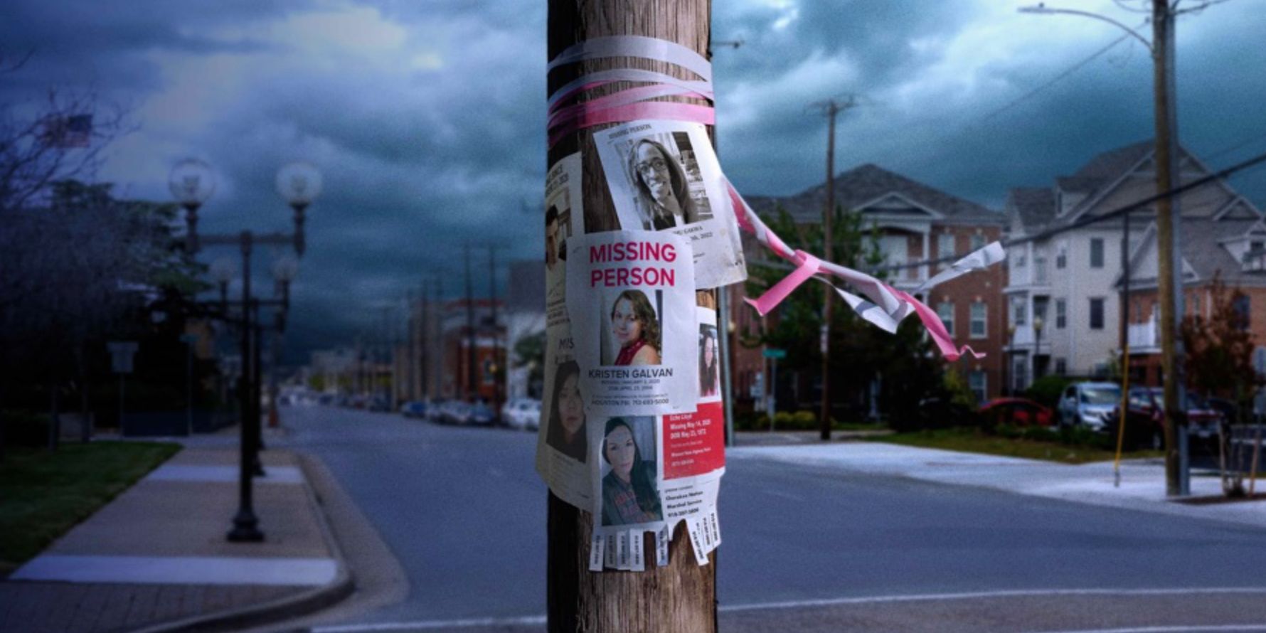 A still from a trailer for Never Seen Again features a telephone pole on a deserted street covered in missing persons posters