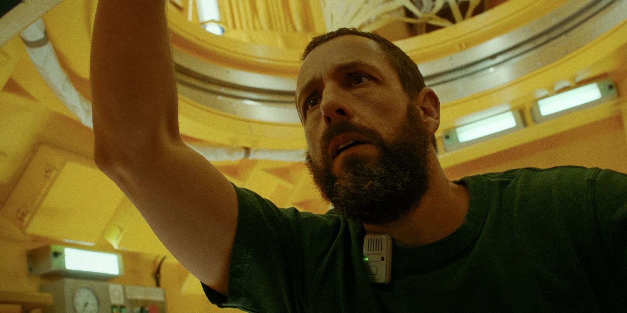 Adam Sandler holds onto a part of the shuttle in Spaceman