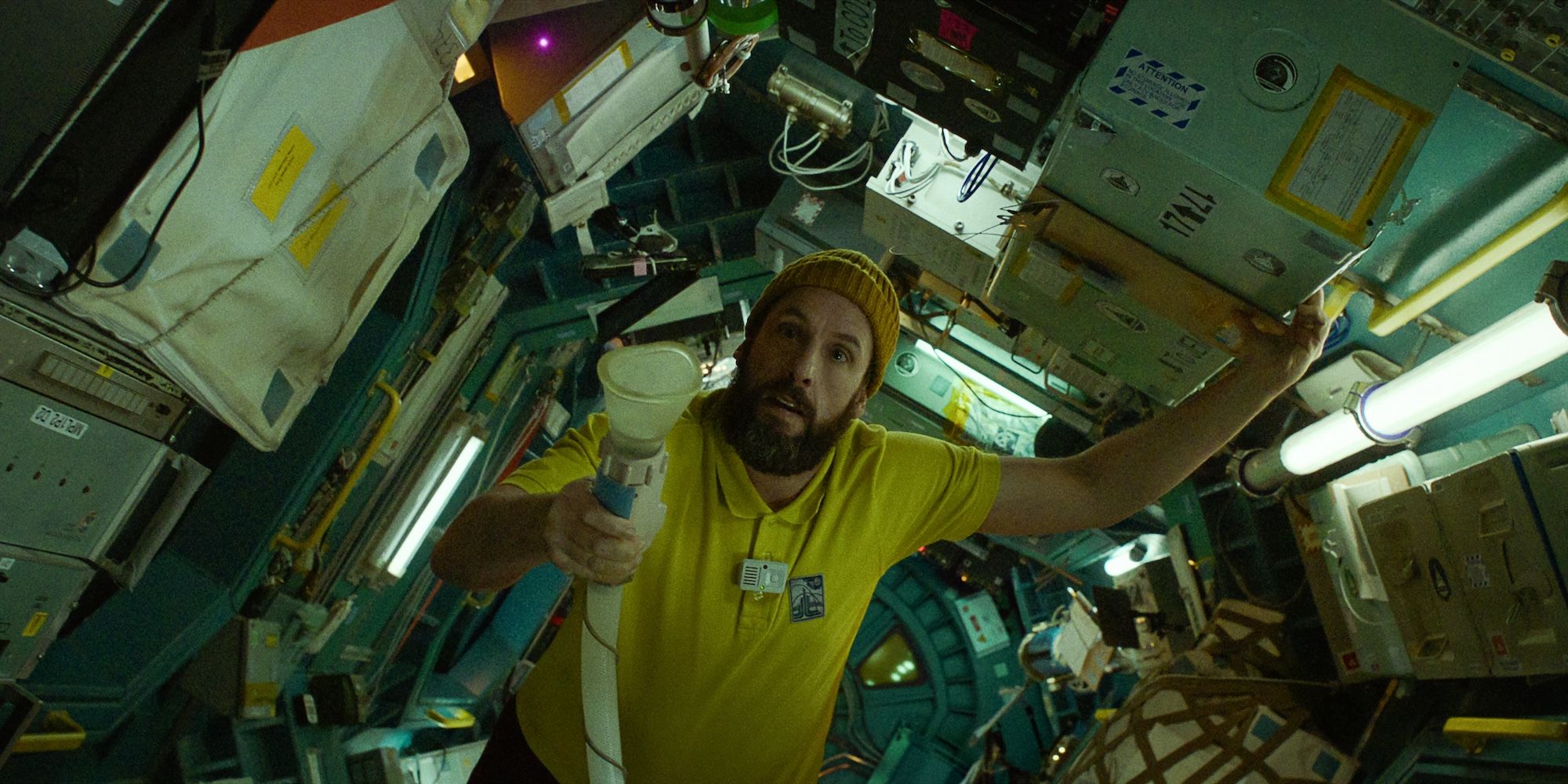 Adam Sandler struggles through the shuttle in Spaceman