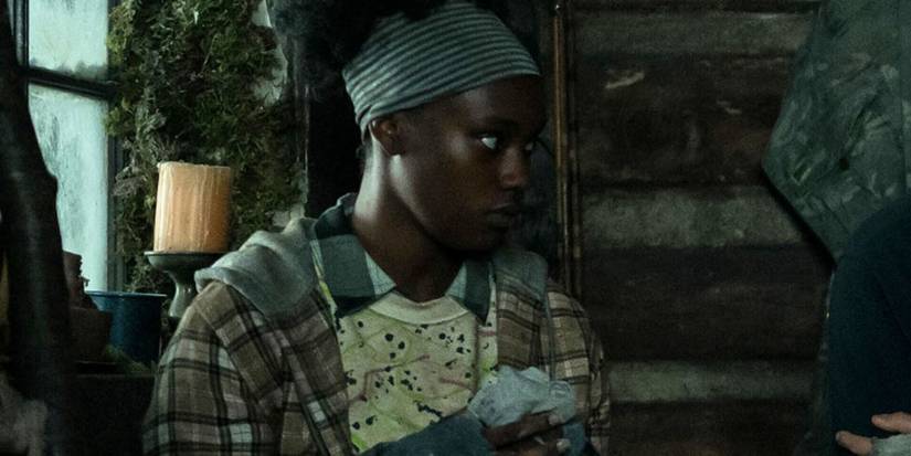 Akilah looks serious in the cabin in Yellowjackets
