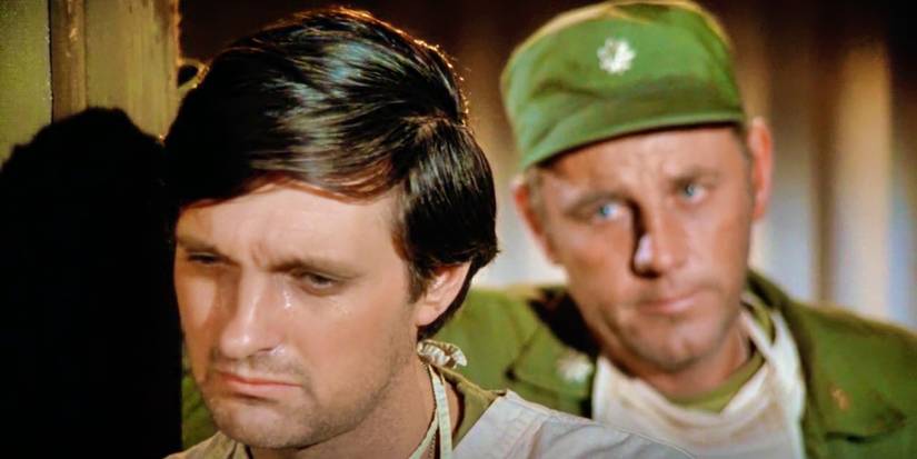 Alan Alda's Hawkeye cries and is comforted by Blake (McLean Stevenson) in MASH's "Sometimes You Hear The Bullet"
