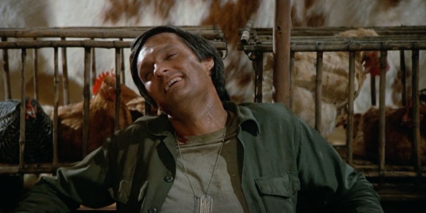 Alan Alda's Hawkeye sits with some chickens in MASH season 4's 