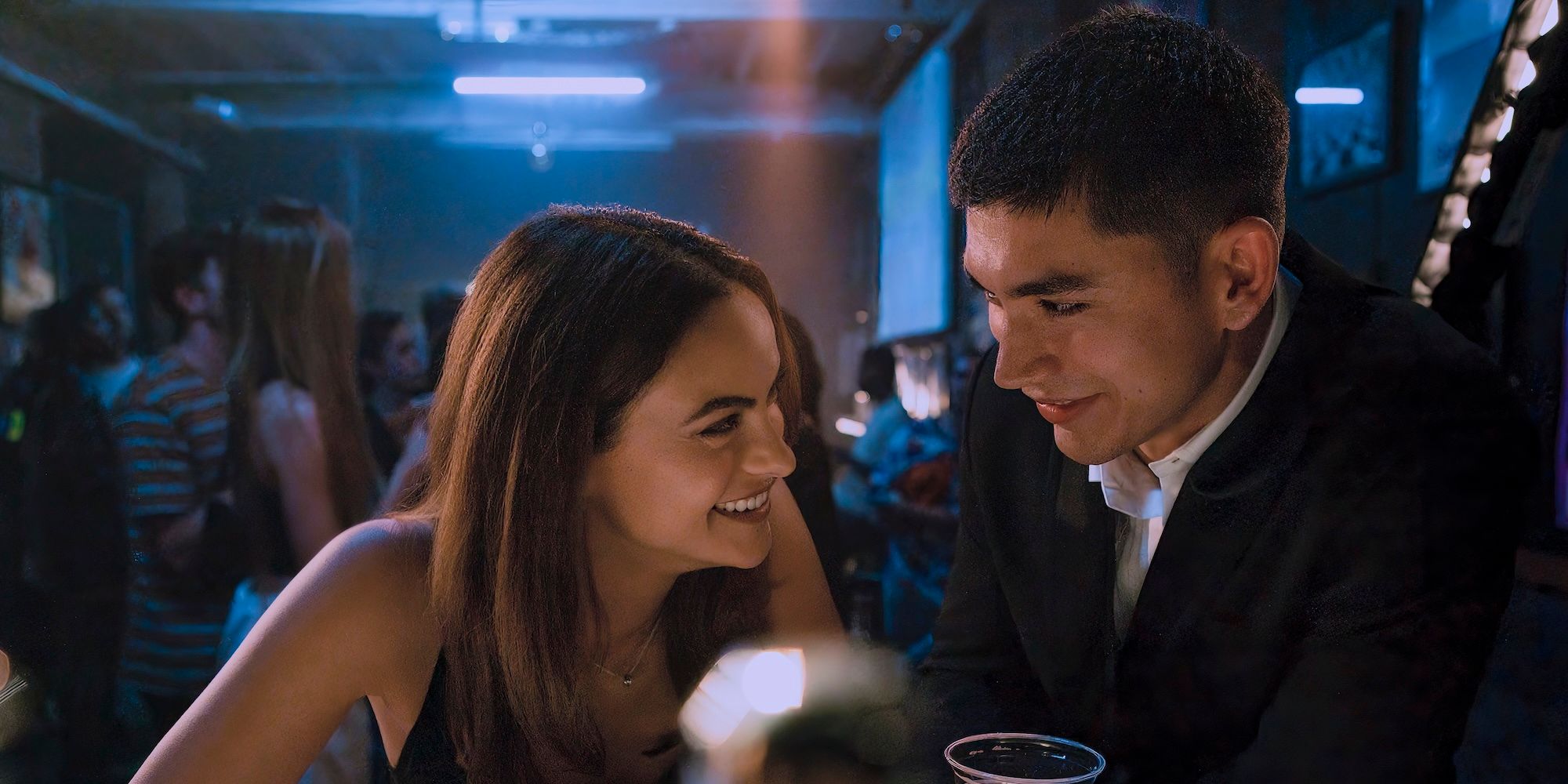 Ana and William laugh together in a club in Upgraded