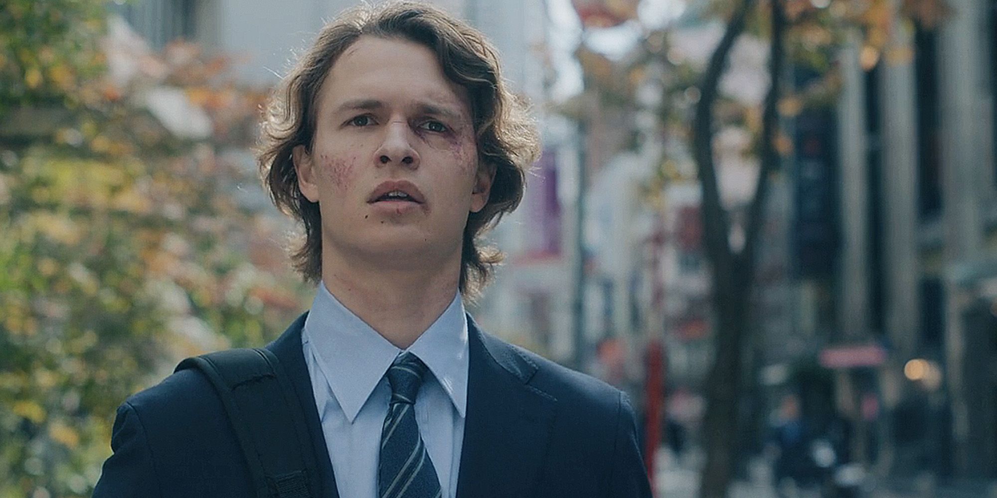 Ansel Elgort as Jake Adelstein with a black eye looking on sadly in Tokyo Vice season 2