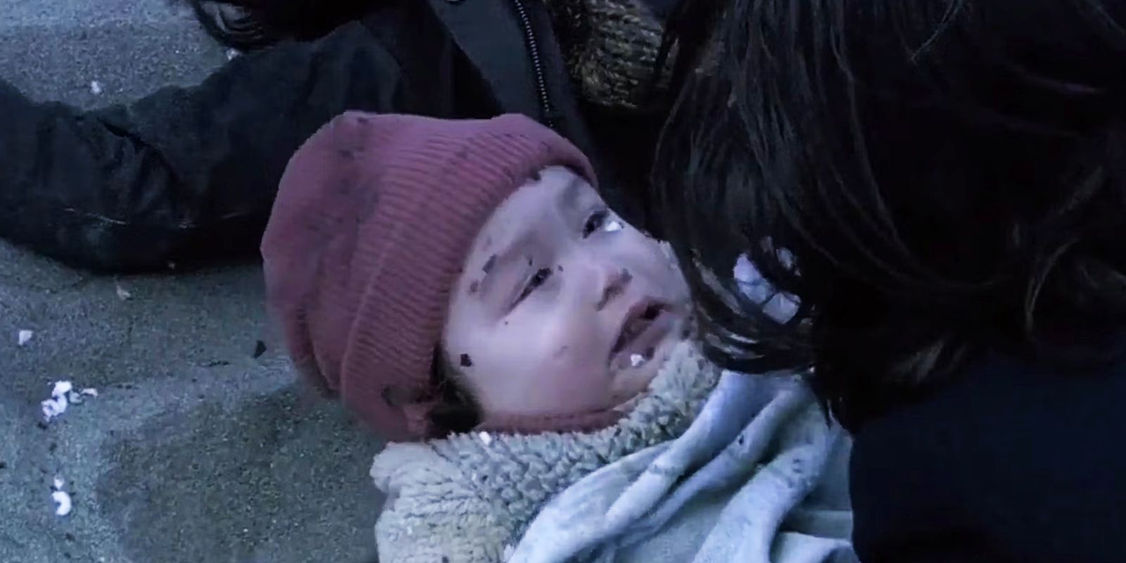 A woman holds baby Hera Agathon in Battlestar Galactica.