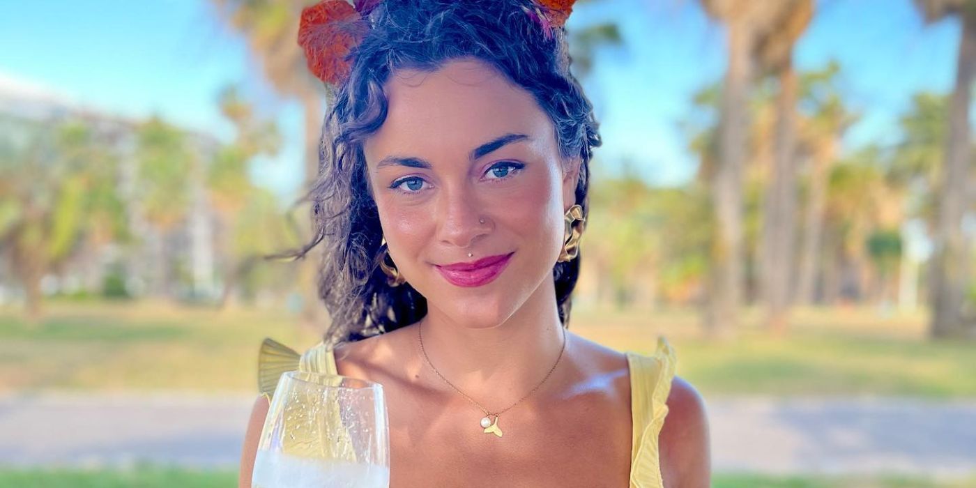 Below Deck Marie Marquis Instagram Post where she is closed-mouth smiling while holding a wine glass
