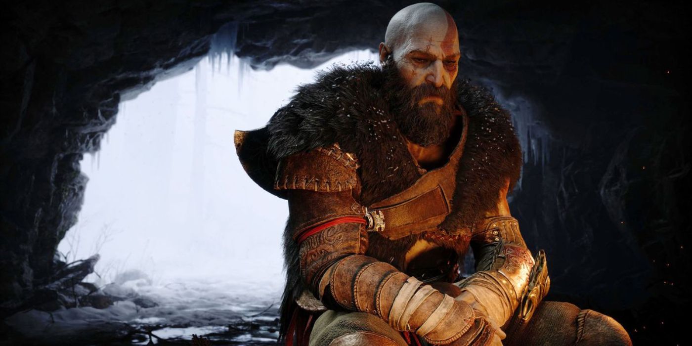 Kratos sentado em uma caverna perto do fogo em God of War: Ragnarök